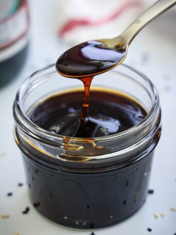 Mason jar of Unagi Sauce, a spoon drizzling some in