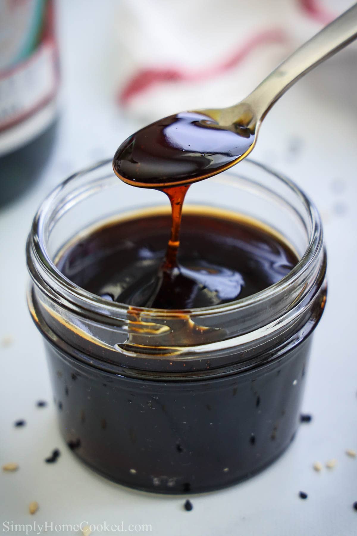 Mason jar of Unagi Sauce, a spoon drizzling some in