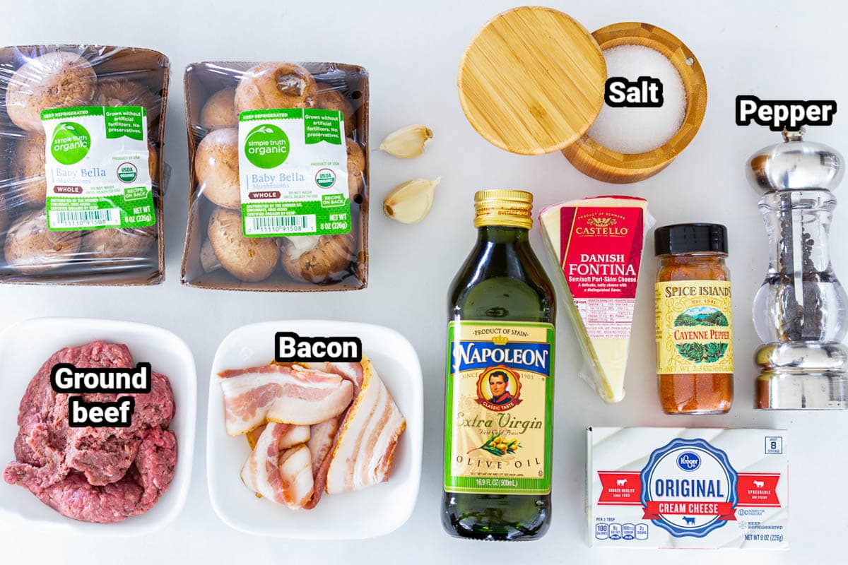 Filled with beef, bacon, and cheese, these Easy Stuffed Mushrooms with Cream Cheese are an ideal appetizer for any event with their creamy rich flavor. #stuffedmushrooms #grilledmushrooms #mushroomrecipe #mushroomappetizer #grilledappetizer Ingredients for Keto Stuffed Mushrooms: baby bella mushrooms, ground beef, bacon, salt, pepper, cayenne, garlic, olive oil, fontine, and cream cheese.