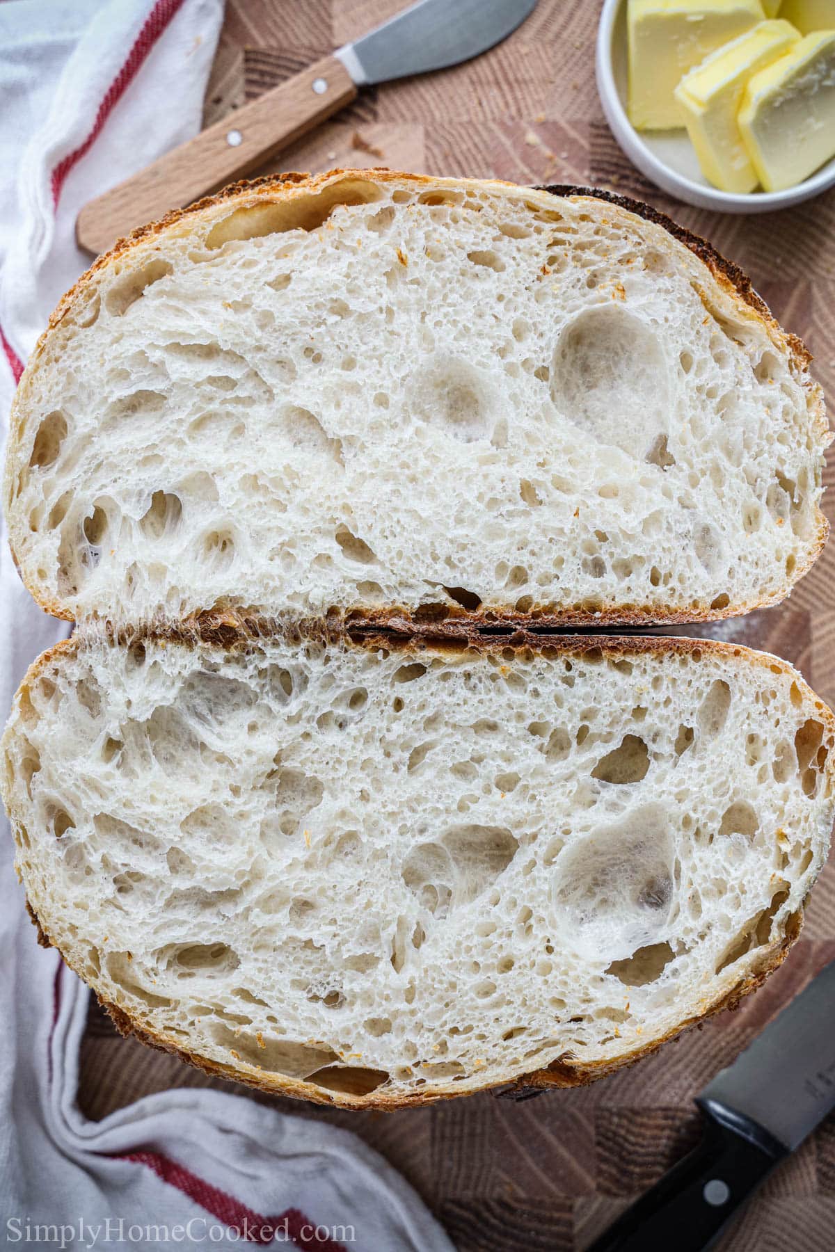 Sliced Sourdough Bread loaf with some butter on the side.