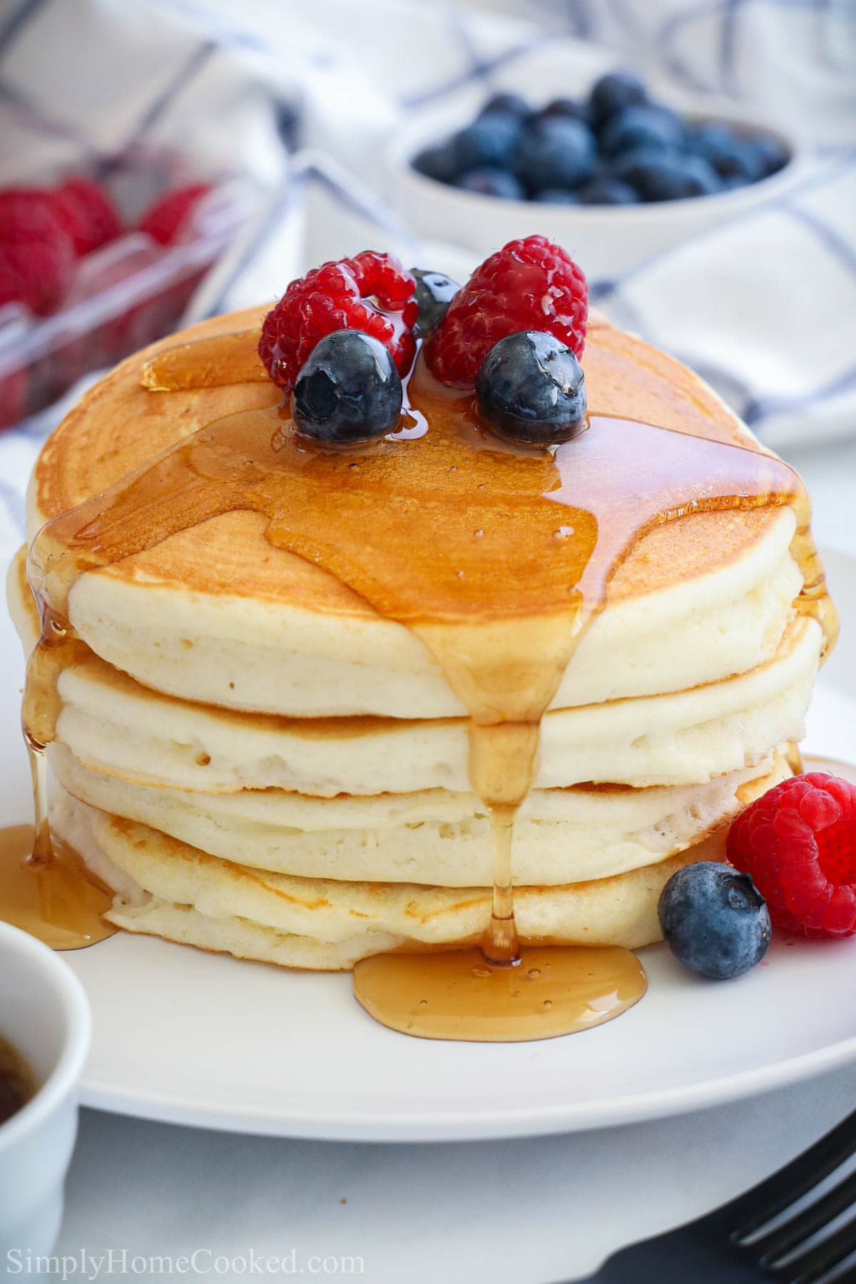 Homemade Buttermilk Pancake Batter Recipe is one everyone needs to have on hand for fast and delicious breakfast to feed their family. #pancakes #buttermilkpancakes #homemadepancakes #bestpancakes #pancakebatter Stack of Buttermilk Pancakes topped with berries and syrup