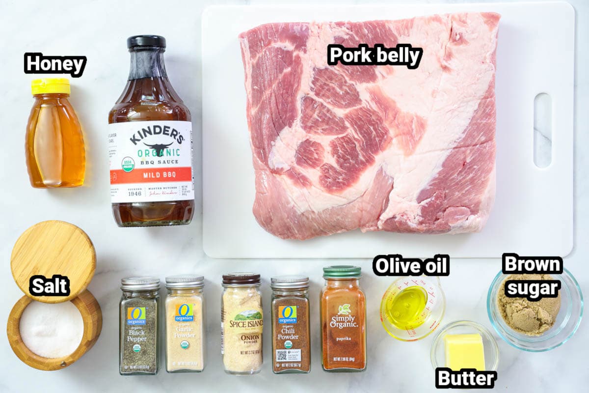 Ingredients for Pork Belly Burnt Ends: pork belly, honey, bbq sauce, salt, pepper, brown sugar, butter, oil, garlic powder, onion powder, paprika, and chili powder.