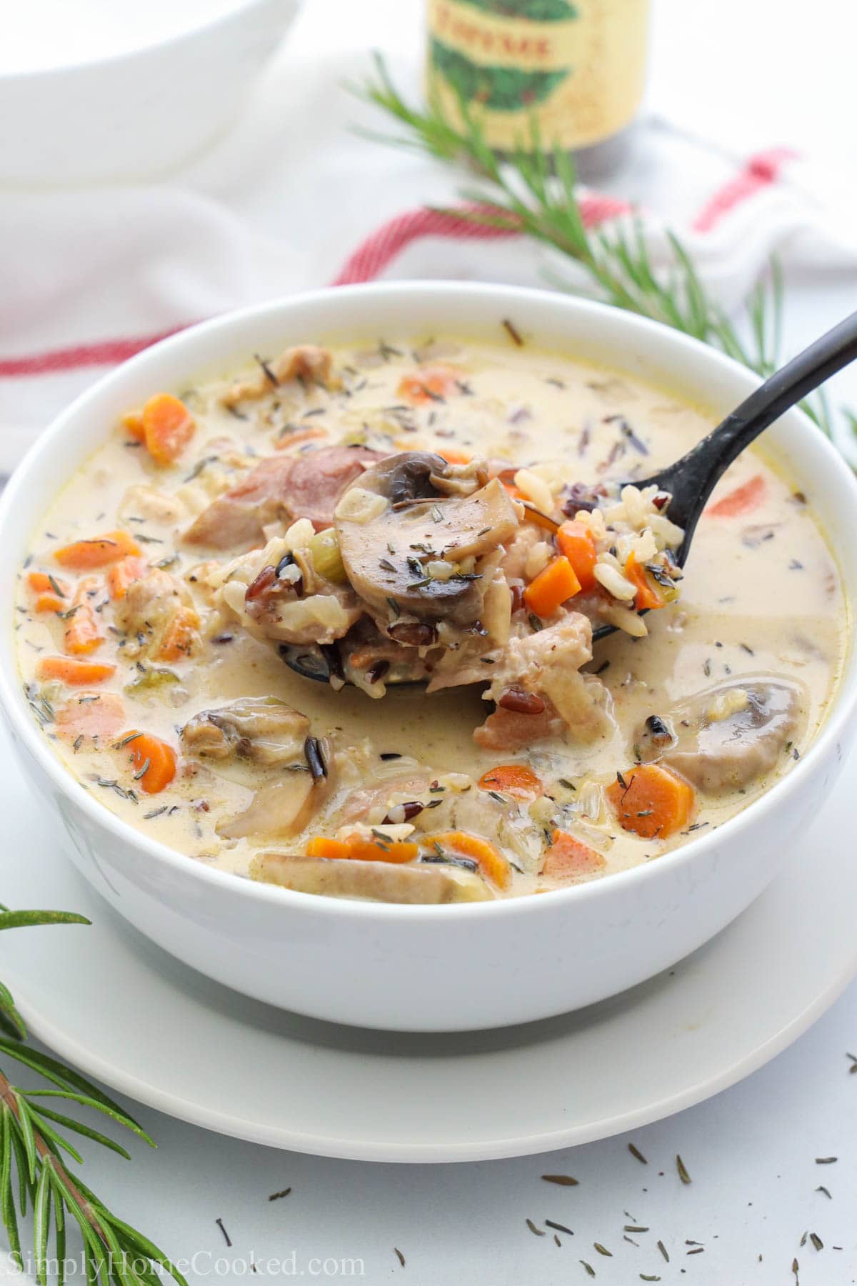 Bowl of Chicken Wild Rice Soup with a spoonful being lifted out.