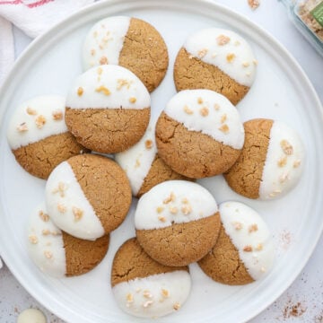 Plate of Gingersnap Cookies with spices and chocolate wafers nearby.