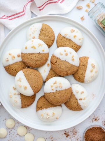 Plate of Gingersnap Cookies with spices and chocolate wafers nearby.