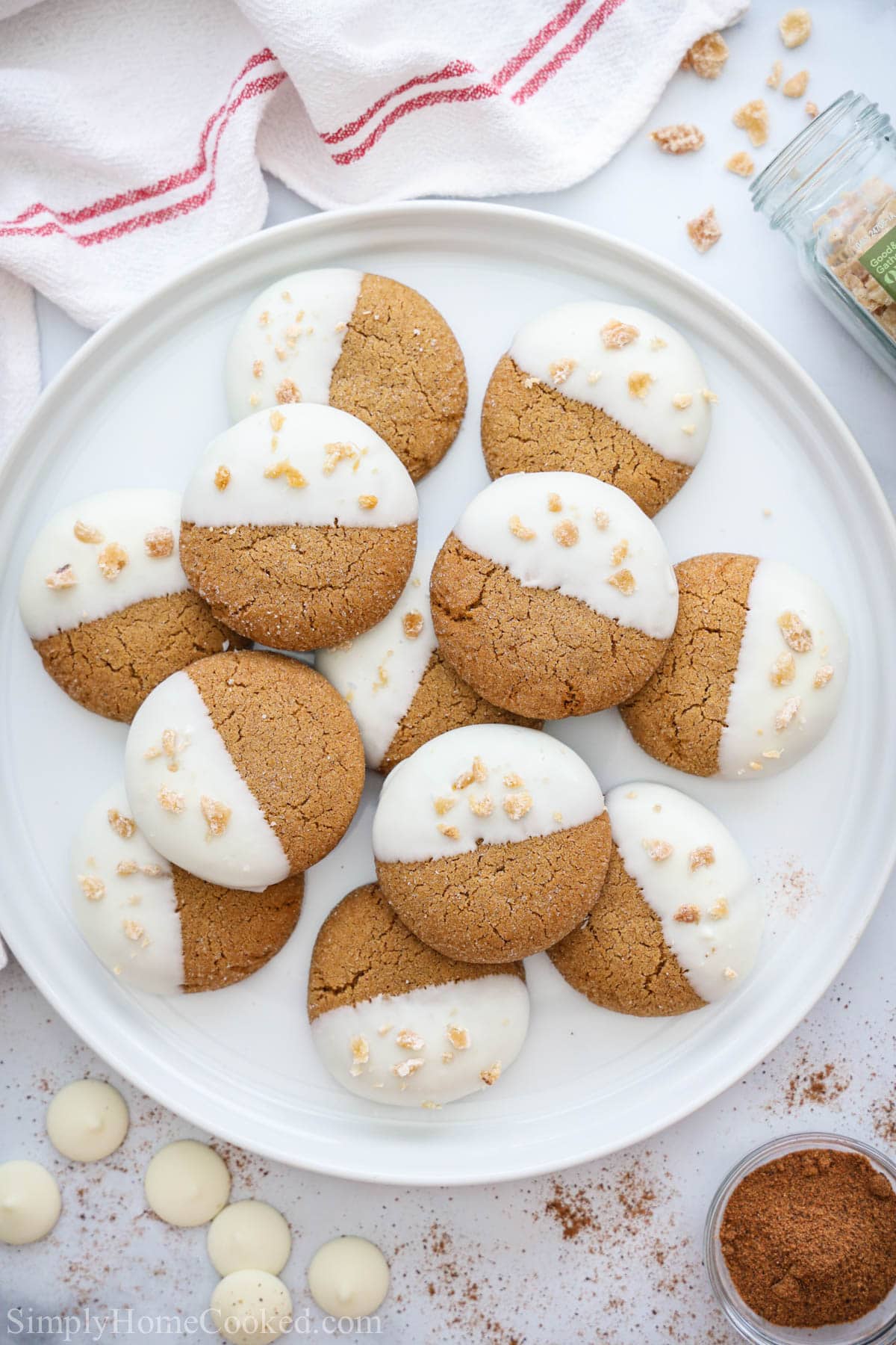Plate of Gingersnap Cookies with spices and chocolate wafers nearby.