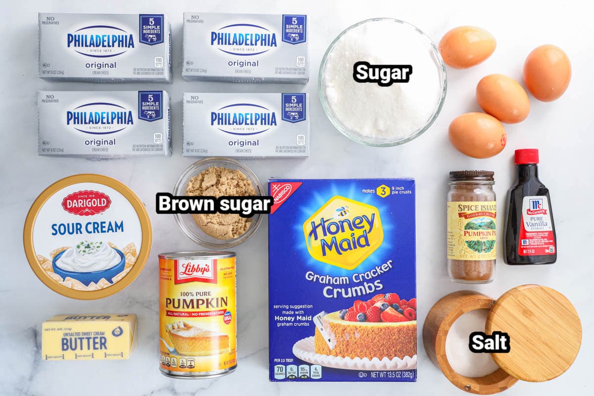 Ingredients for Pumpkin Cheesecake Bars: cream cheese, sugar, eggs, sour crea, brown sugar, pumpkin puree, butter, graham cracker crumbs, pumpkin spice, vanilla, and salt.