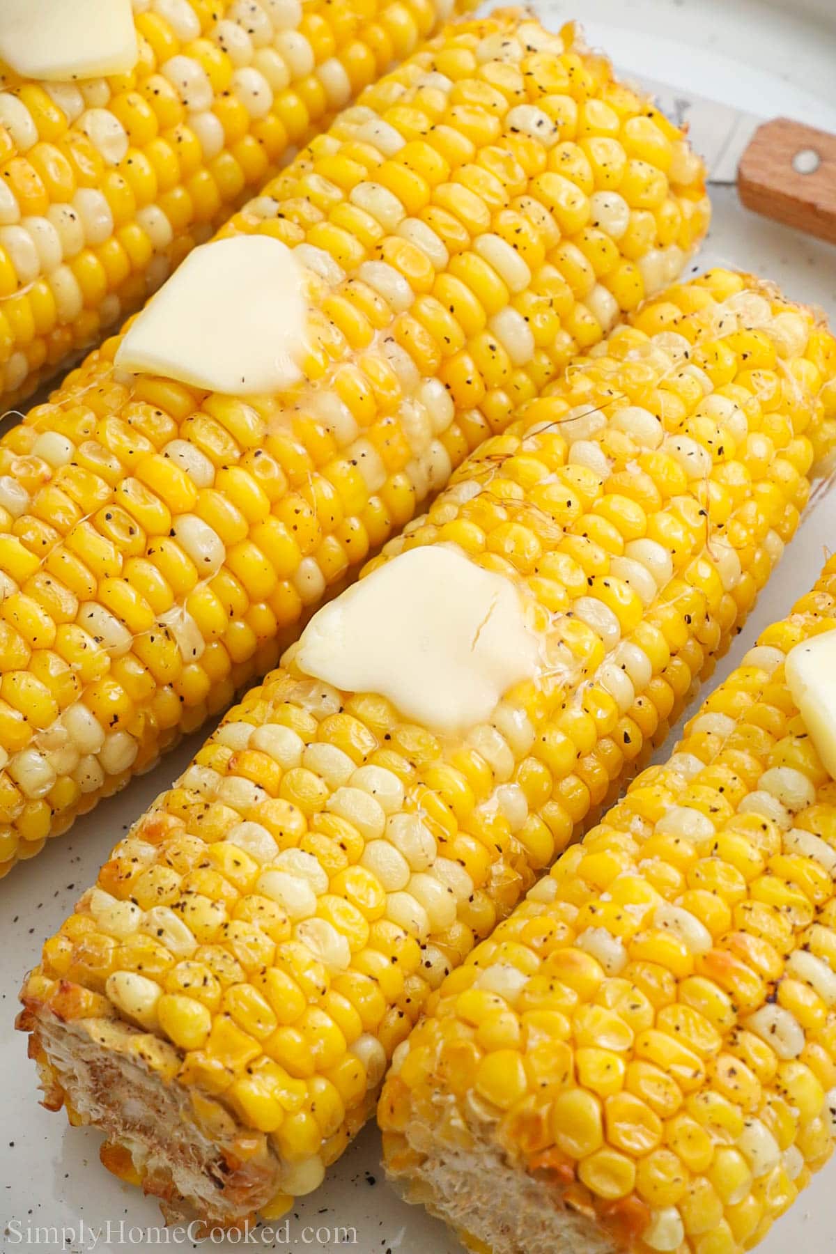 Air Fryer Corn on the Cob covered in pads of melting butter.