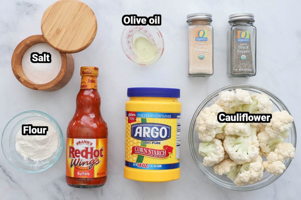 Ingredients for Air Fryer Buffalo Cauliflower: cauliflower corn starch, hot sauce, flour, salt, pepper, garlic powder, and oi.