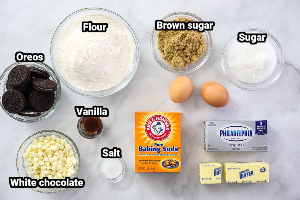 Ingredients for Cookies and Cream Cookies: flour, brown sugar, sugar, Oreos, vanilla, eggs, baking soda, salt, white chocolate chips, butter, and cream cheese.