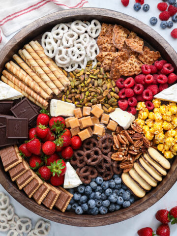 Dessert Charcuterie Board with berries and pretzels nearby