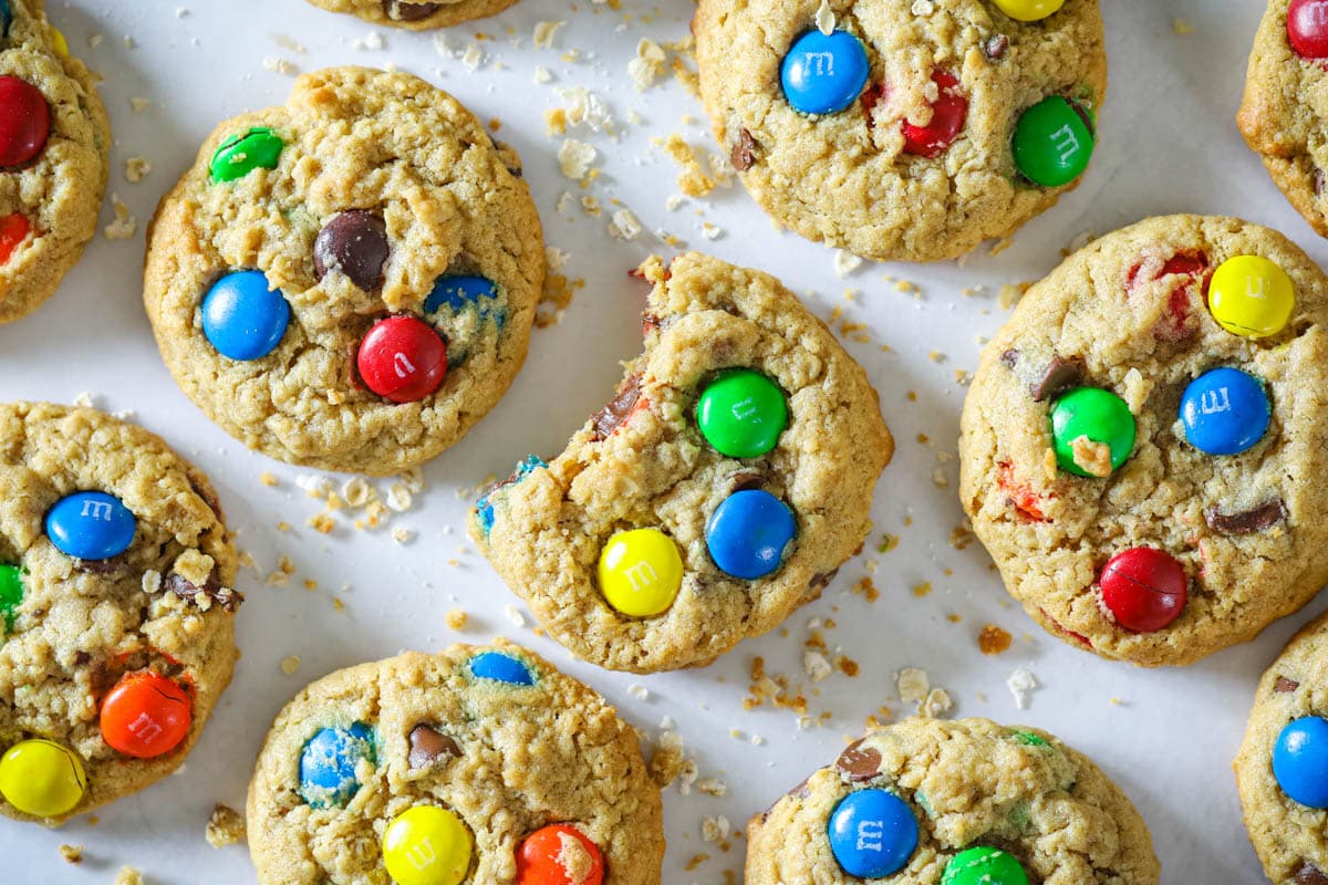 These chewy Monster cookies are full of chocolate, oats, and peanut butter, making them moist and delicious. You'll love the flavor and texture of the easy to make cookies. #easymonstercookies #simplecookierecipe #homemadeoatmealcookies #Monstercookierecipe #easytomakecookierecipe Monster Cookies