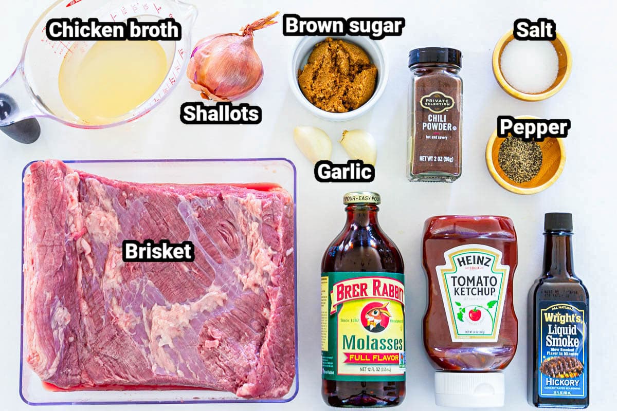 Ingredients for Beef Brisket Sandwich: chicken broth, shallots, brown sugar, garlic, chili powder, salt, pepper, ketchup, liquid smoke, molasses, and brisket.