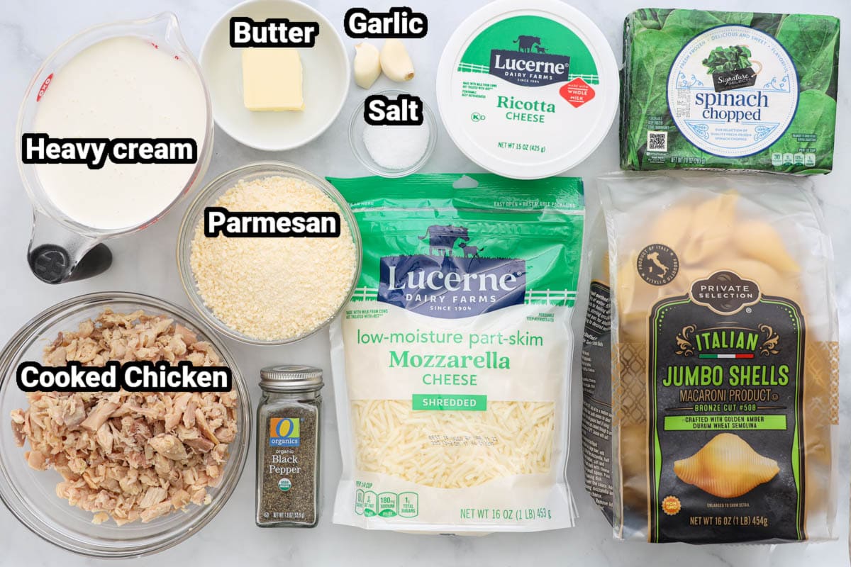 Ingredients for Chicken Stuffed Shells: heavy cream, butter, garlic cloves, salt, pepper, cooked chicken, mozzarella cheese, spinach, ricotta cheese, parmesan cheese, and shells.