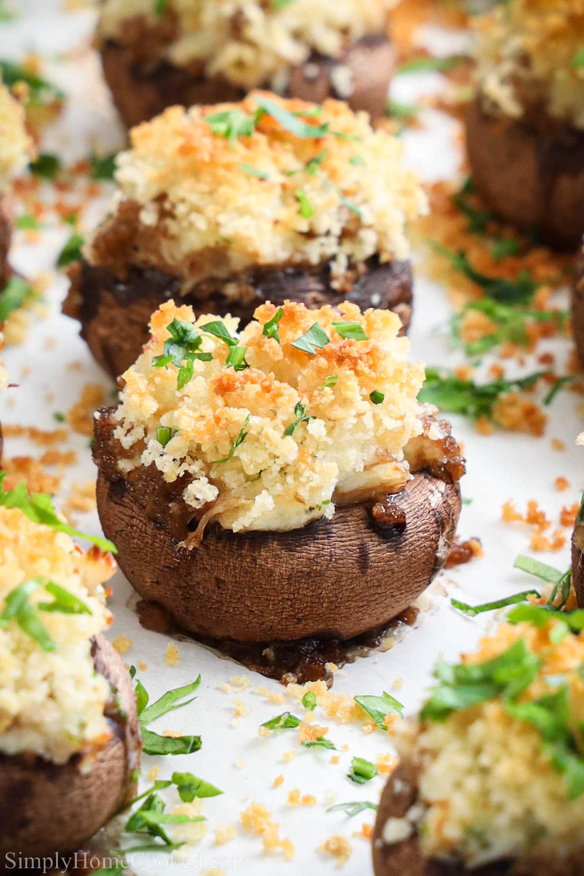 Closeup of Crab Stuffed Mushrooms covered in Panko breadcrumbs and parsley.