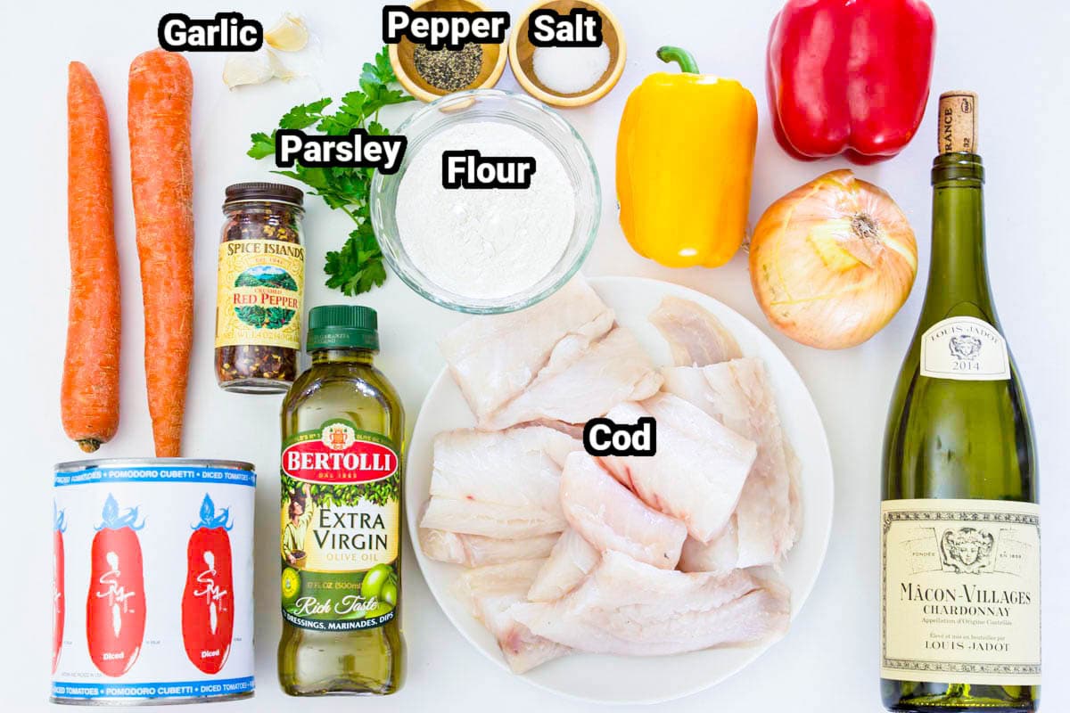 Ingredients for Pan Fried Cod with Sauteed Vegetables: carrots, garlic, parsley, flour, salt, pepper, yellow and red peppers, white wine, cod, red pepper flakes, oil, diced tomatoes, and onion.