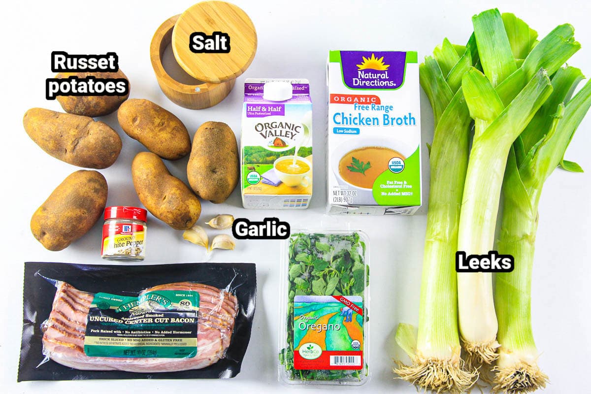 Ingredients for Potato Leek Soup: russet potatoes, salt, cream, chicken broth, leeks, bacon, white pepper, garlic cloves, and oregano.