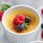 creme brluee with berries and mint on top.
