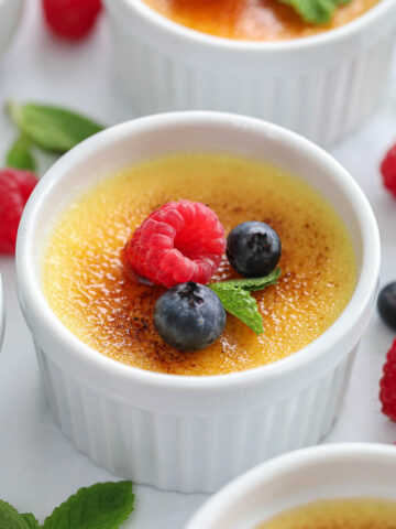 creme brluee with berries and mint on top.