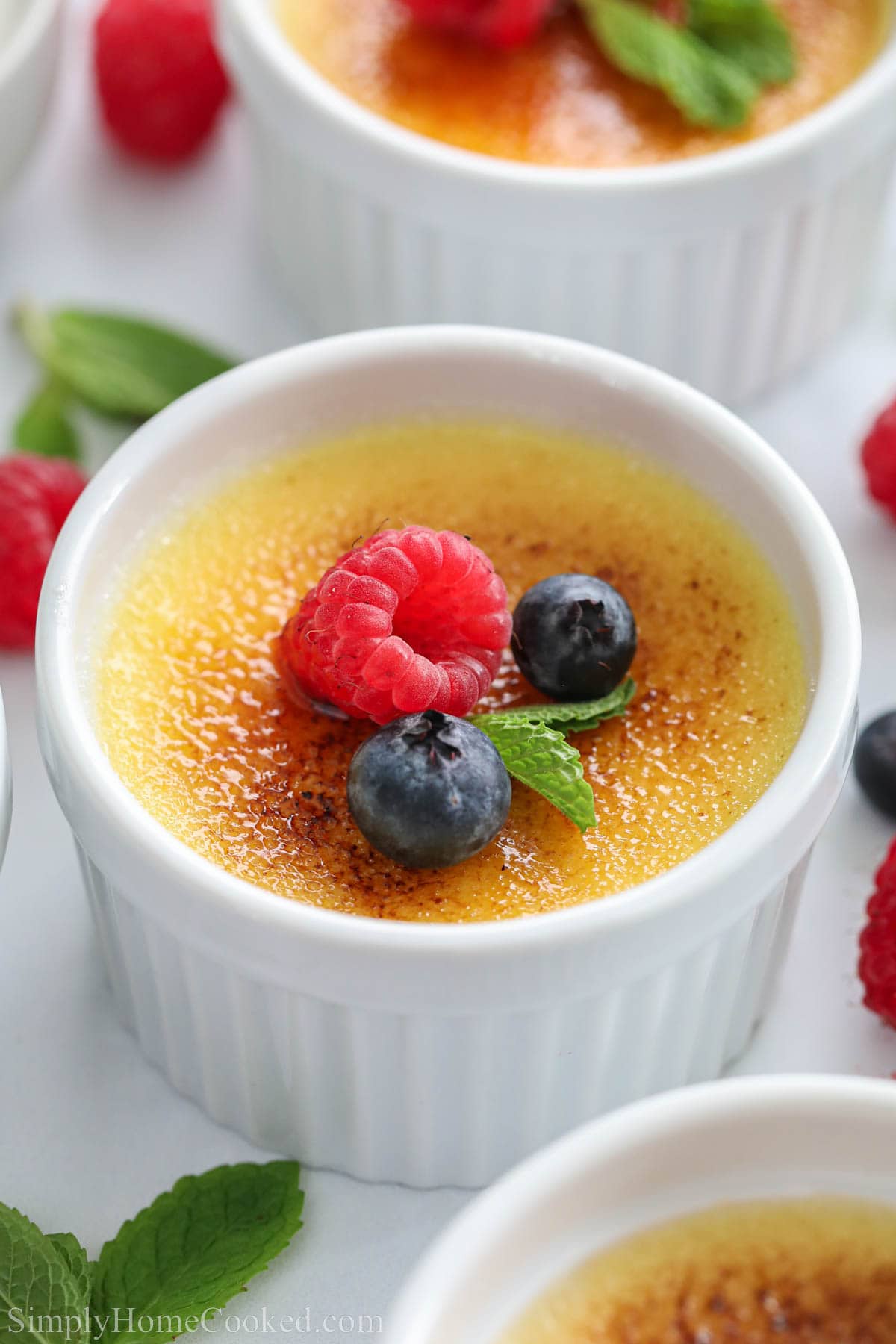 creme brluee with berries and mint on top.