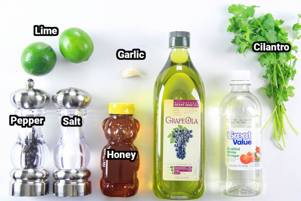 Ingredients for Cilantro Lime Dressing: limes, garlic, cilantro, white vinegar, grapeseed oil, honey, salt, and pepper.