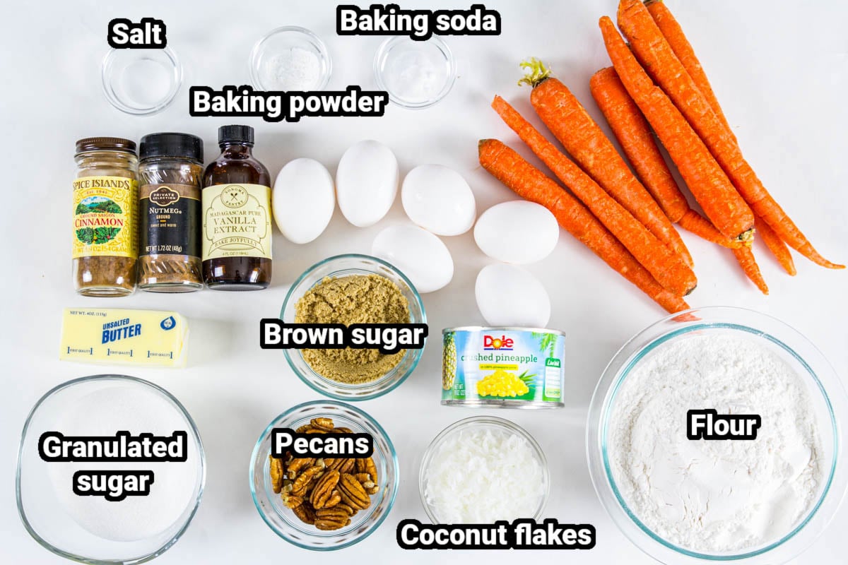 Ingredients for Easy Carrot Cake: flour, carrots, coconut flakes, pecans, brown sugar, pineapple, sugar, eggs, butter, cinnamon, vanilla, nutmeg, salt, baking powder, and baking soda.