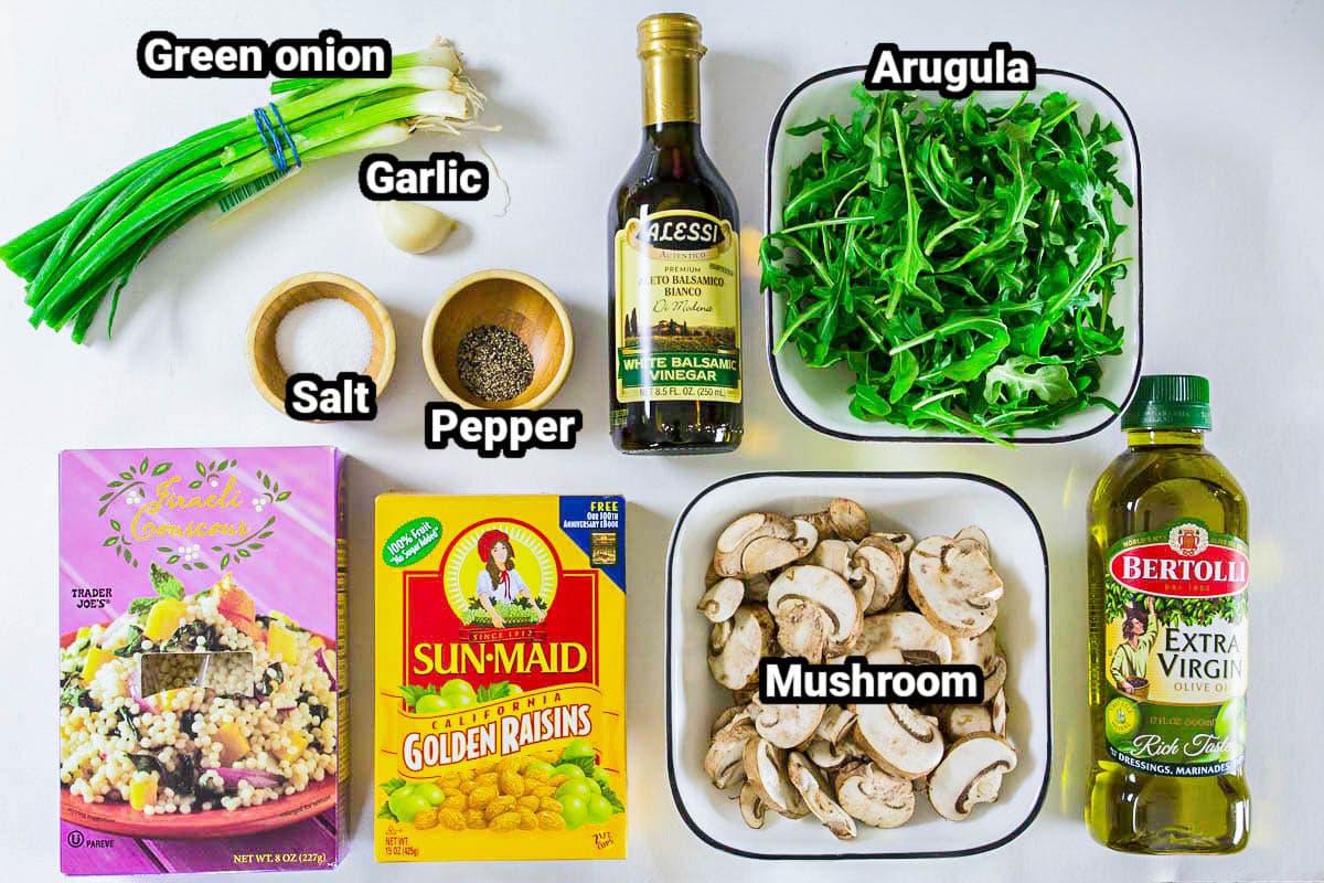 Ingredients for Couscous Arugula Salad: couscous, golden raisins, mushrooms, olive oil, arugula, white balsamic vinegar, salt, pepper, garlic clove, and green onion.