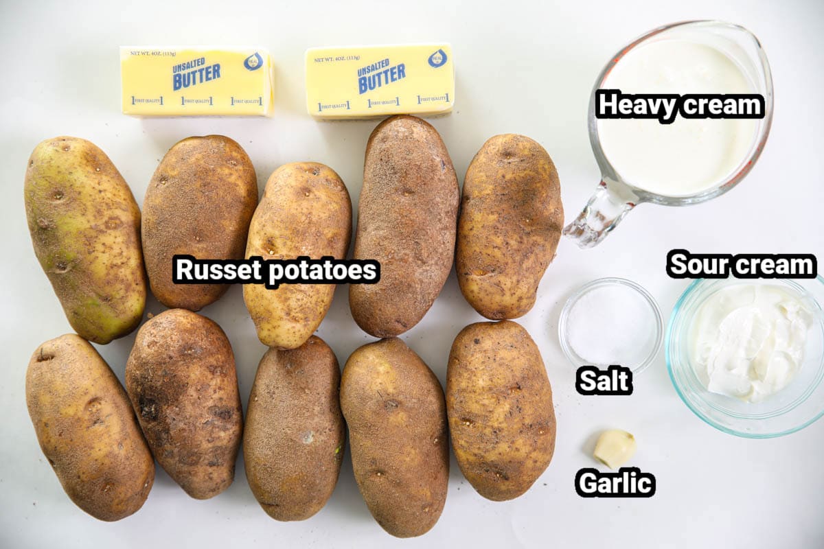 Ingredients for Super Creamy Mashed Potatoes: russet potatoes, butter, heavy cream, sour cream, salt, and garlic.