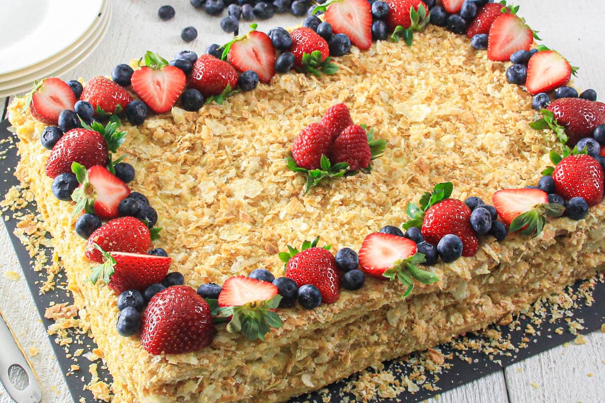 Easy Napoleon Cake topped with fresh berries.