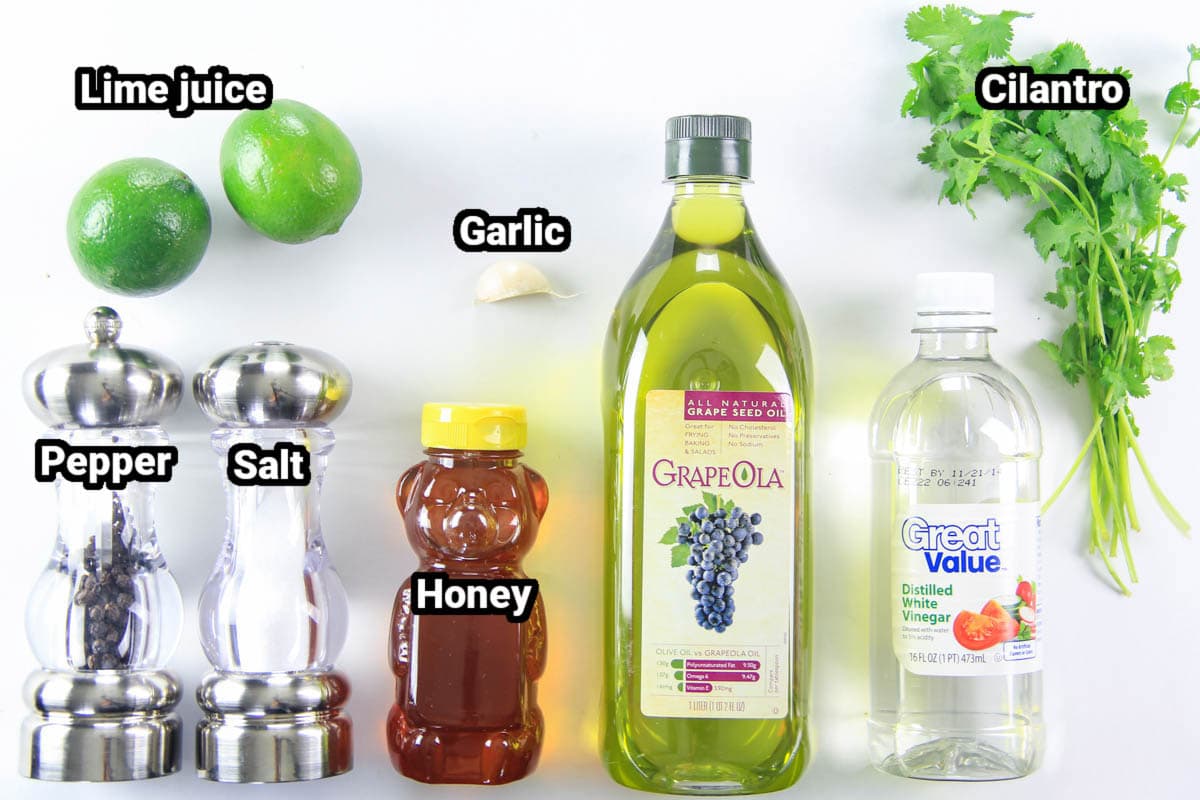 Ingredients for Cilantro Lime Dressing: cilantro, limes, grapeseed oil, white vinegar, garlic, honey, salt, and black pepper.