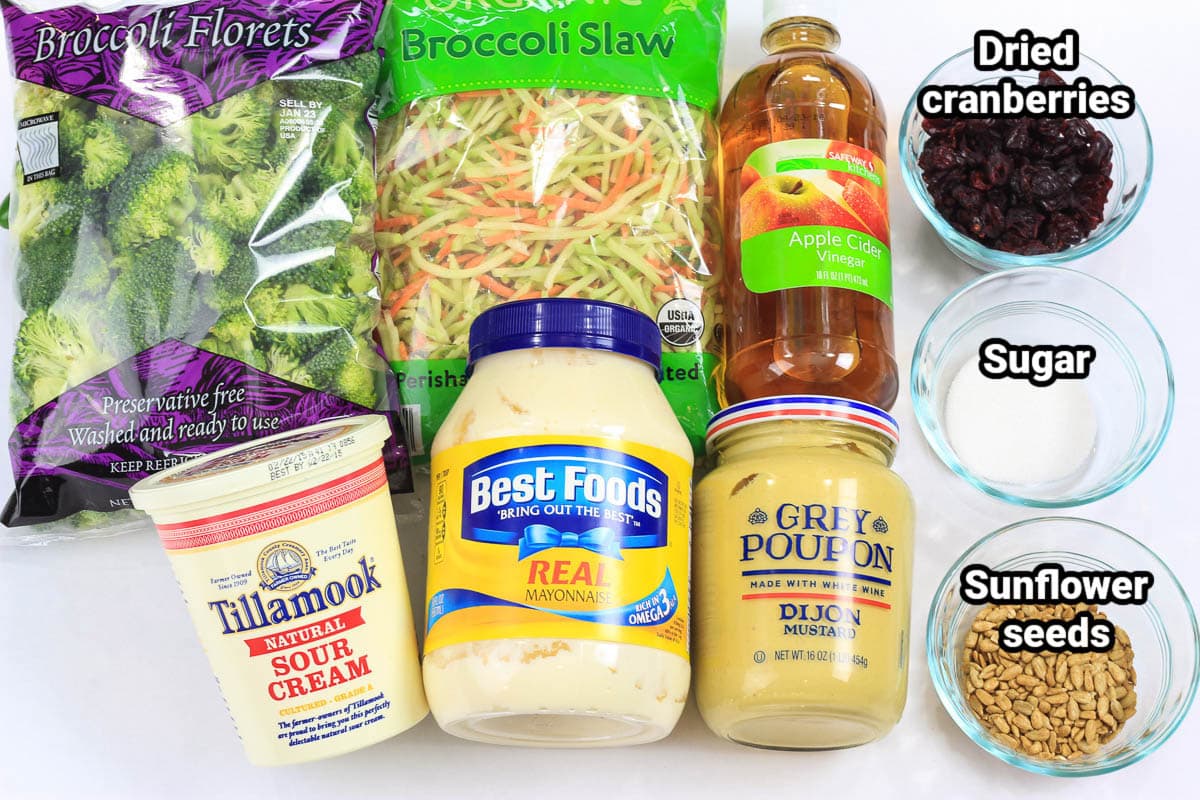 Ingredients for Broccoli Cranberry Salad: broccoli florets, broccoli florets, apple cider vinegar, sour cream, mayonnaise, dijon mustard, cranberries, sunflower seeds, and sugar.