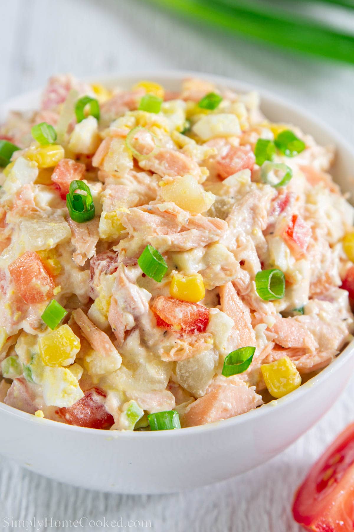 This potato salad recipe is a twist on the basic Russian potato salad (olivye. It's loaded with new potatoes, baked salmon, tomato, corn, and hard-boiled eggs. #potatosalad #russiansalad #olivye #olivier #slavicsalad Salmon Potato Salad.