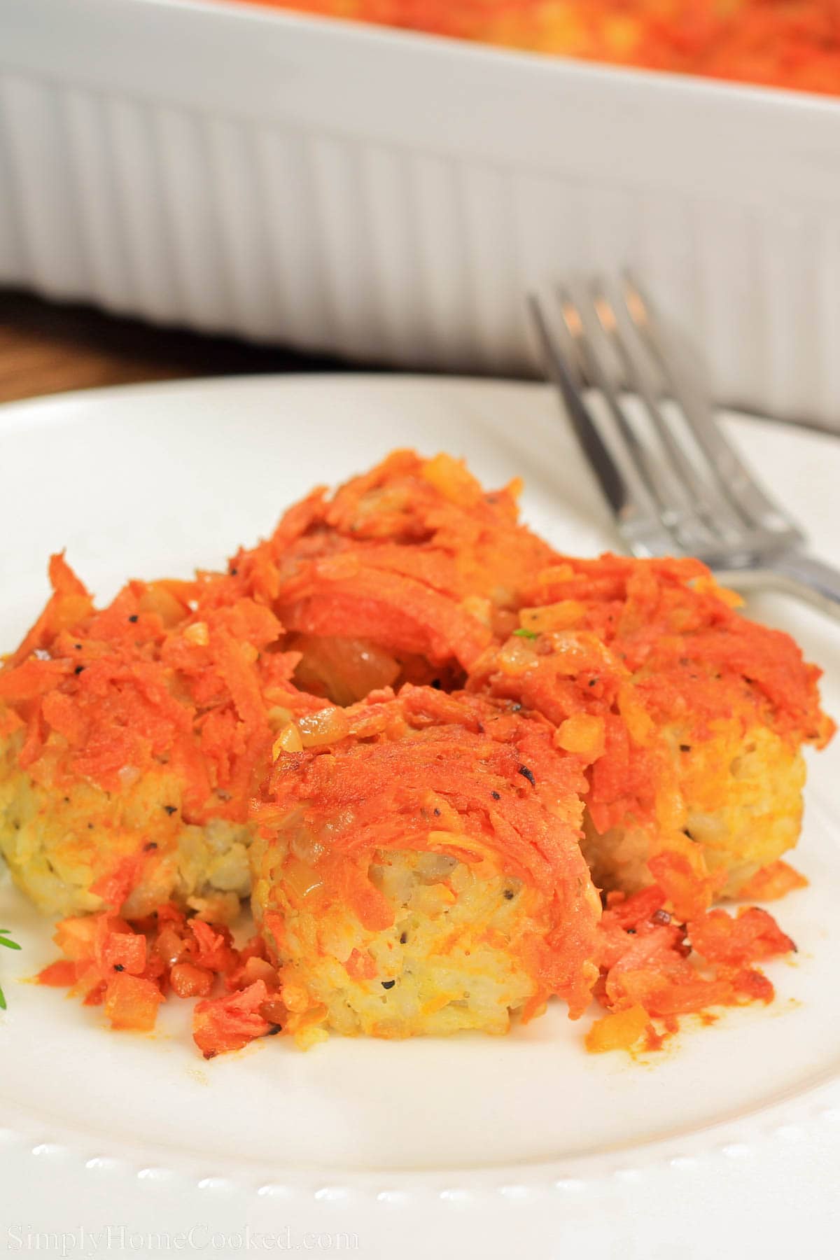 Lazy cabbage rolls, also know as ленивые голубцы. An easy version of Russian cabbage rolls. Stuffed Cabbage Rolls are a wonderfully flavorful combination of ground chicken, vegetables and spices that produce the ultimate comfort food dish. #stuffedcabbagerolls #cabbagerolls #lazycabbagerolls #easyrussianfood #slavicfood #russianweddingfood Lazy Cabbage Rolls covered with sauteed onions and carrots on a plate with a fork.