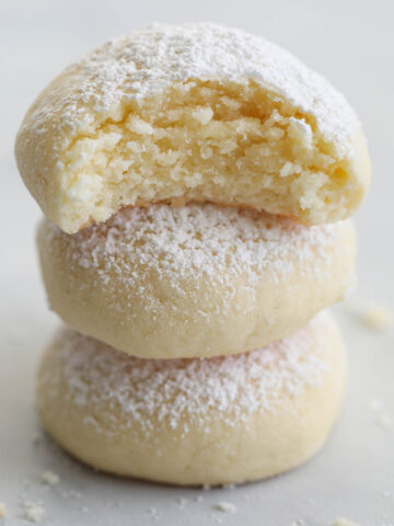 Stack of Cream Cheese Cookies, the top one missing a bite.