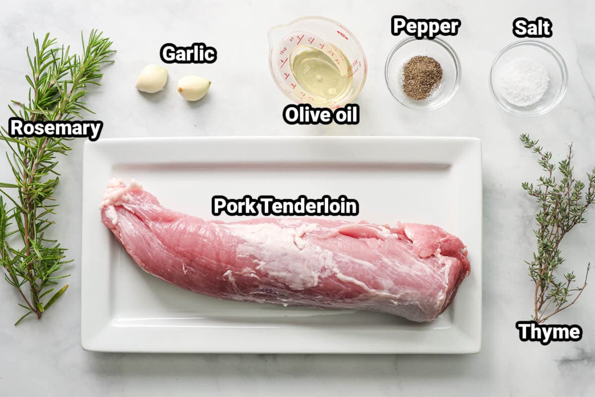 Ingredients for Air Fryer Pork Tenderloin: pork tenderloin, rosemary, thyme, garlic cloves, olive oil, pepper, and salt.