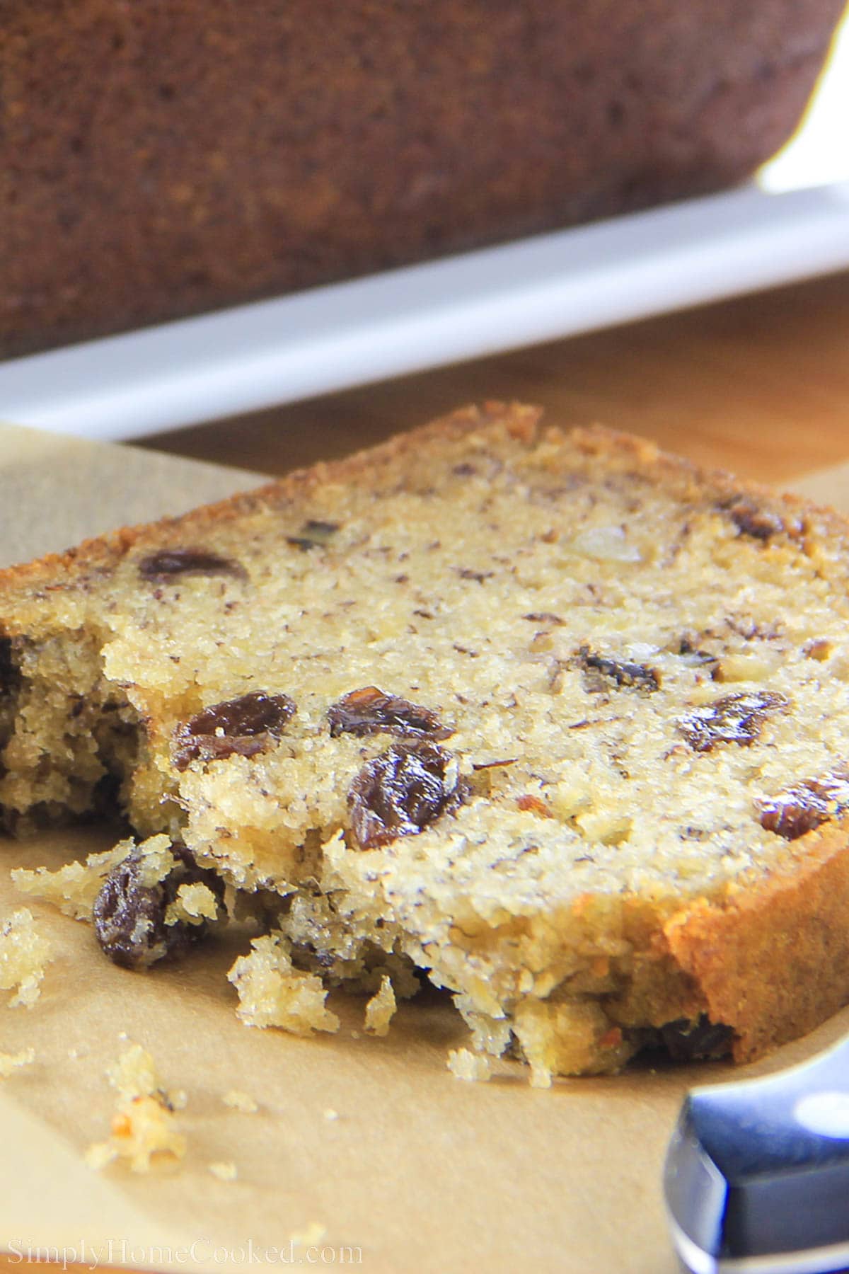 This moist banana walnut bread is loaded with crunchy toasted walnuts and rum-infused raisins. This soft banana bread recipe is a pure delight! #bananabread #walnutbread #breakfastbread #bestbananabread Slice of Banana Walnut Bread.