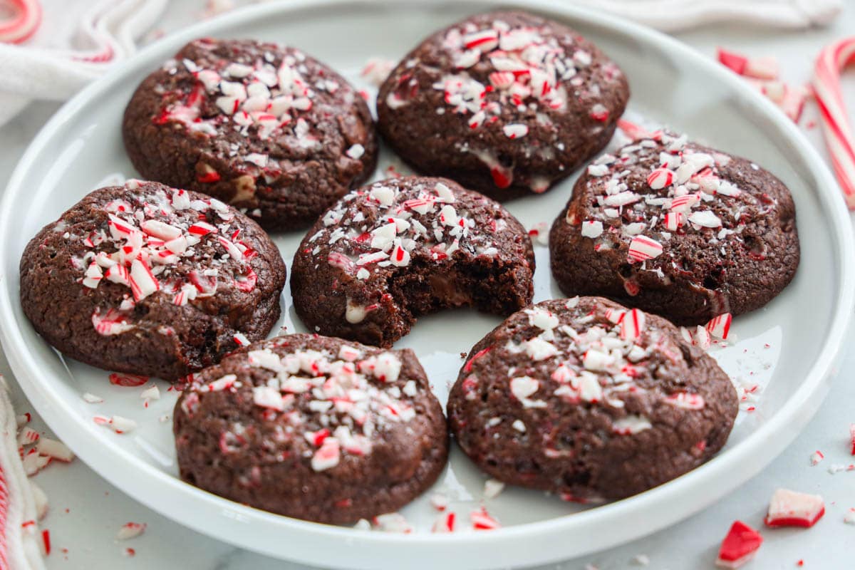 Chocolate Peppermint Cookies on a  plate, one missing a bite.