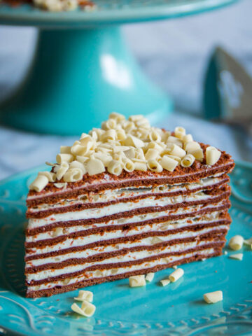 Slice of Chocolate Spartak Cake on a blue plate.