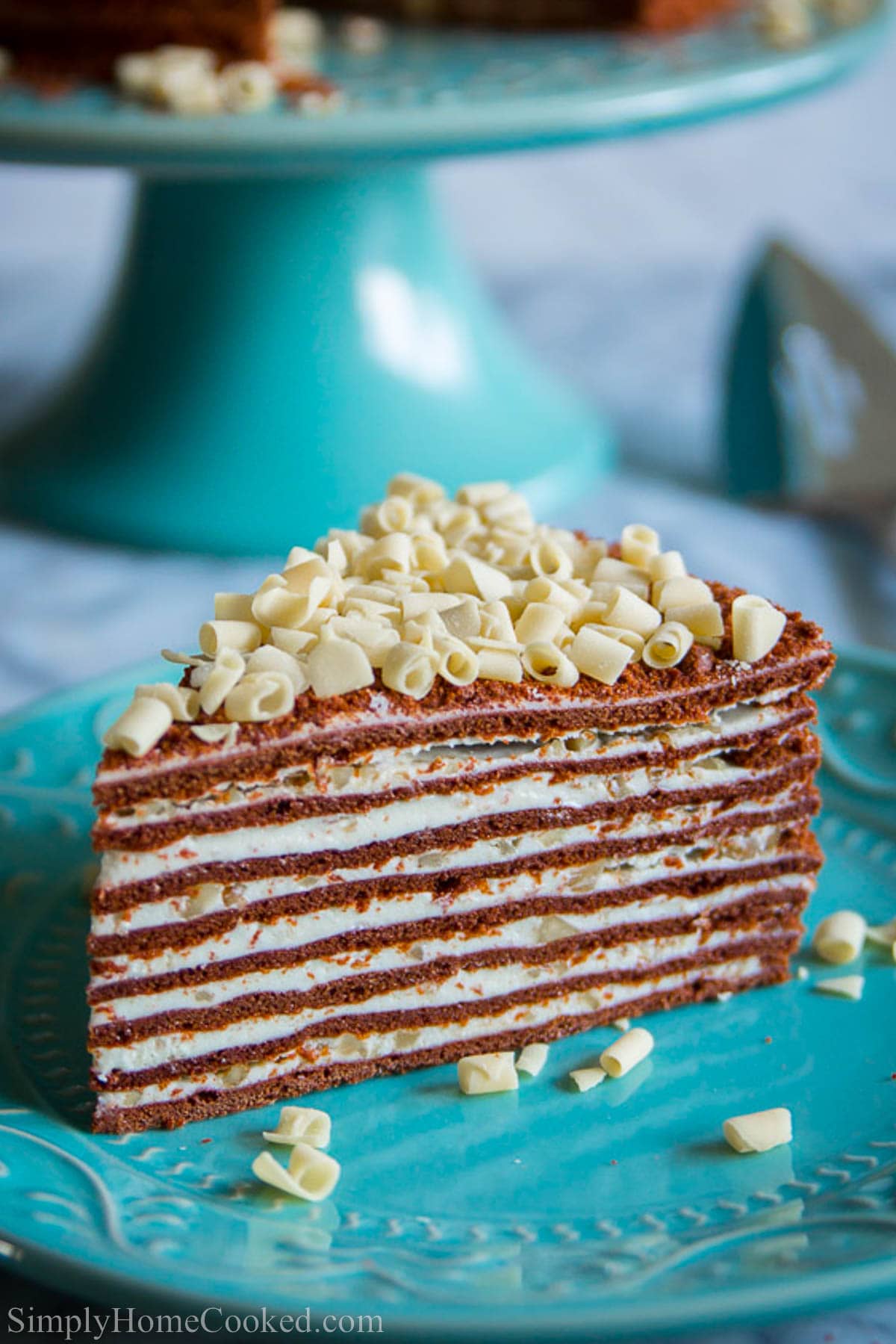 Slice of Chocolate Spartak Cake on a blue plate.