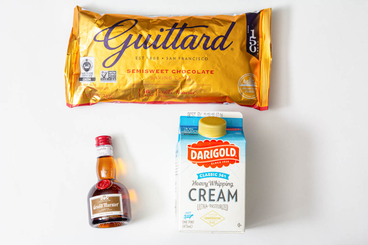 Ingredients for chocolate ganache for Cranberry Orange Bundt Cake: chocolate chips, heavy cream, and Grand Marnier. 