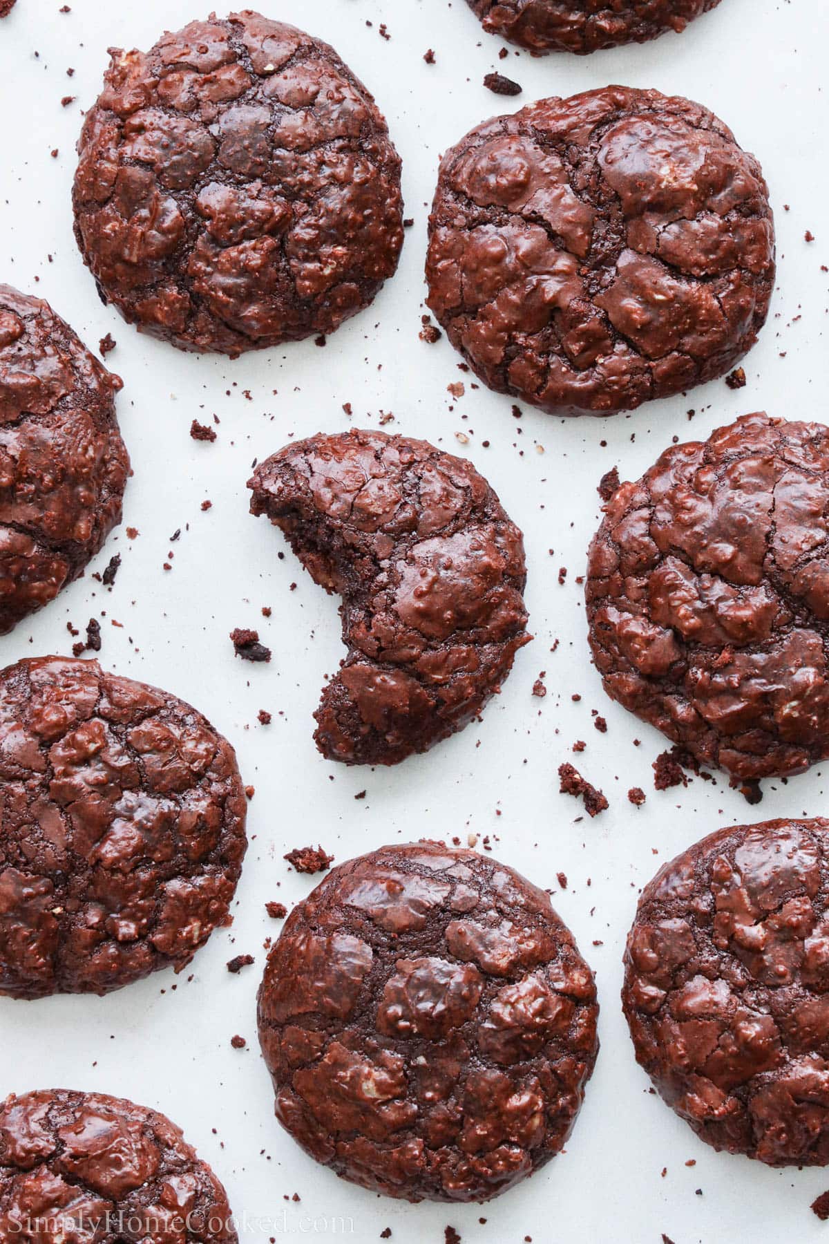 Flourless Chocolate Cookies on a baking sheet with one missing a bite.