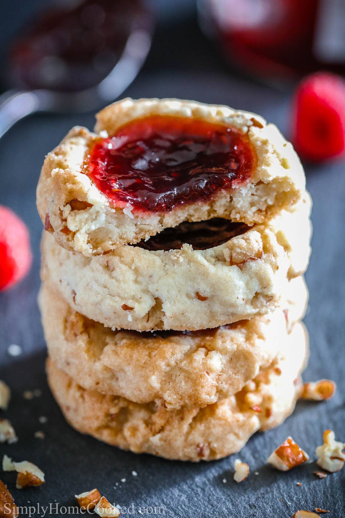 Pile of Raspberry Thumbprint Cookies: the top one missing a bite. 