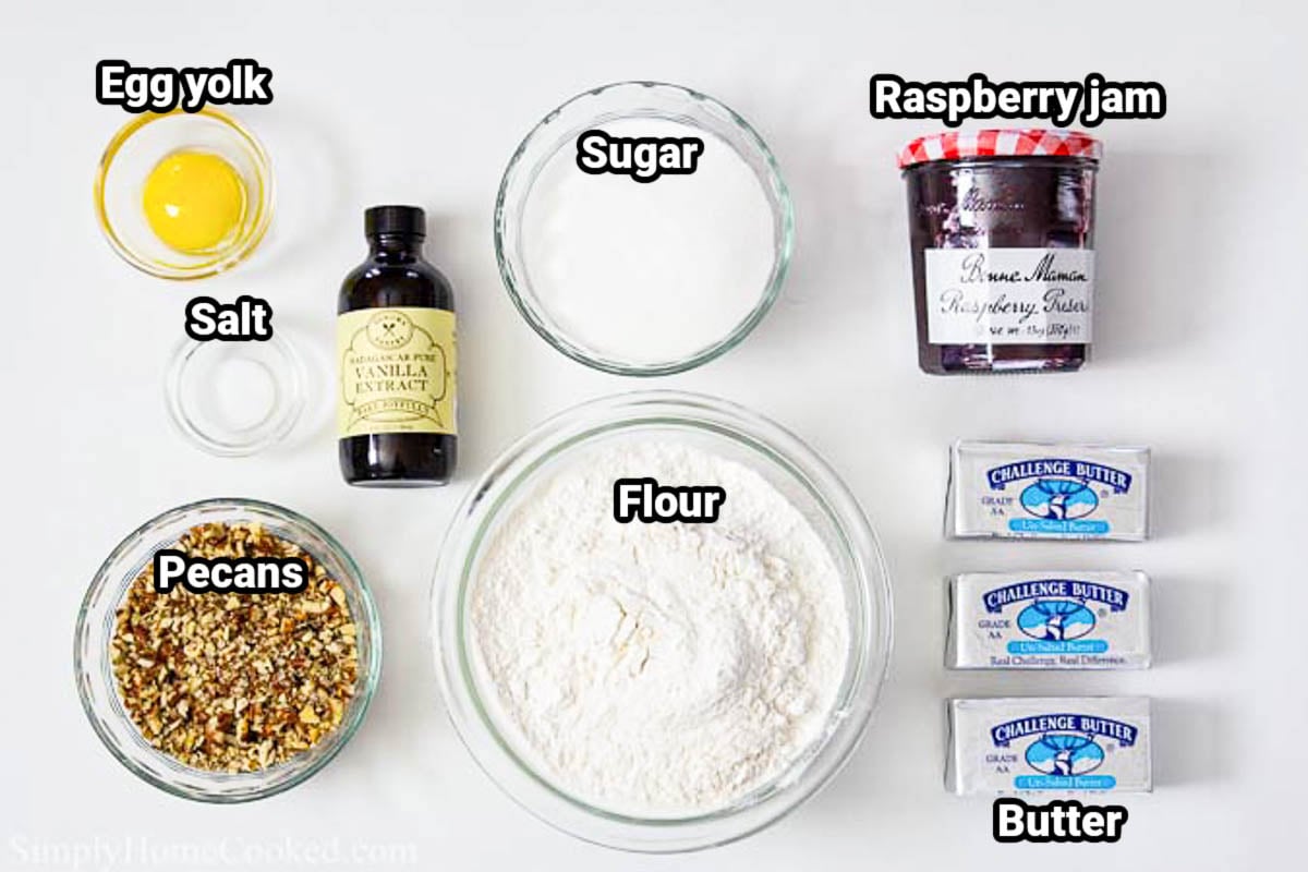 Ingredients for Raspberry Thumbprint Cookies: egg yolk, salt, pecans, vanilla, sugar, flour, raspberry jam, and butter. 