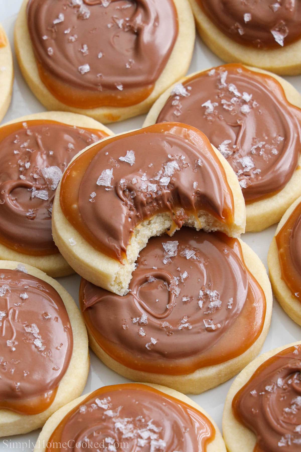 Twix Cookies with the top one missing a bite.