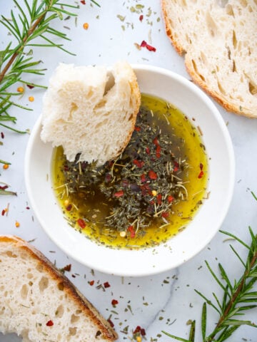 Bread Dipping Oil in a bowl with bread on the side.