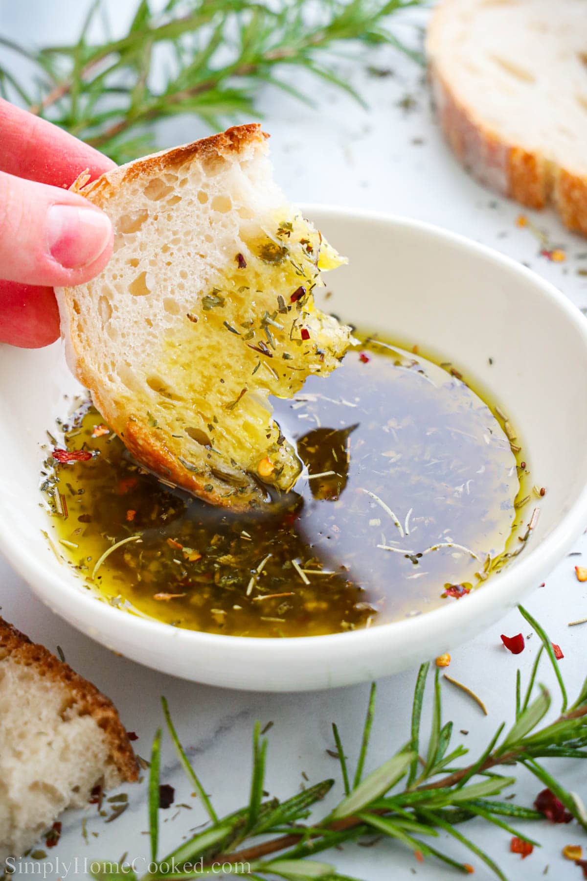 Bread dipped in a bowl of Bread Dipping Oil.