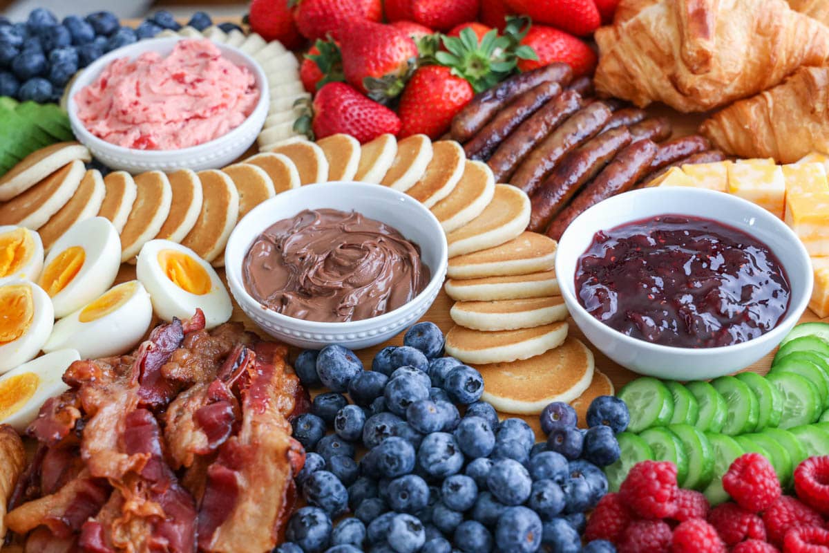 Breakfast Charcuterie Board with pastries, spreads, meats, and fruit.