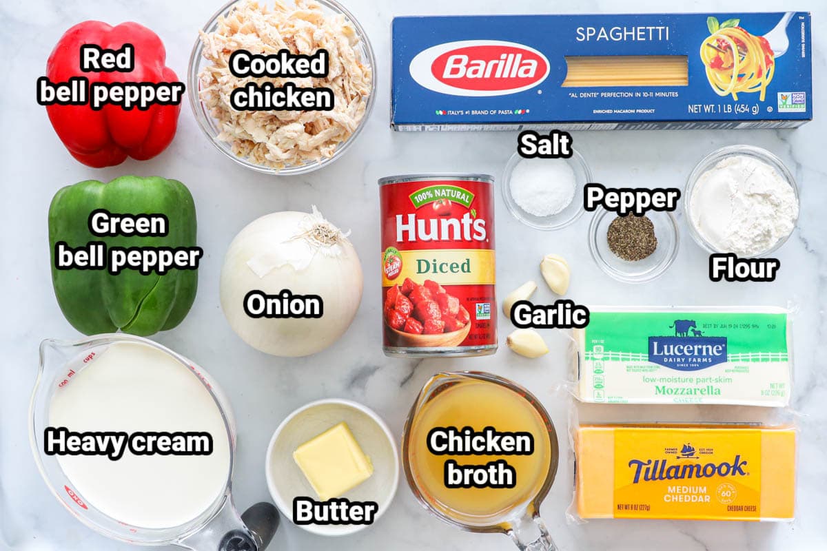 Ingredients for Chicken Spaghetti: red pepper, green pepper, onion, garlic, chicken, diced tomatoes, heavy cream, spaghetti, butter, chicken broth, salt, pepper, flour, cheddar cheese, and mozzarella.