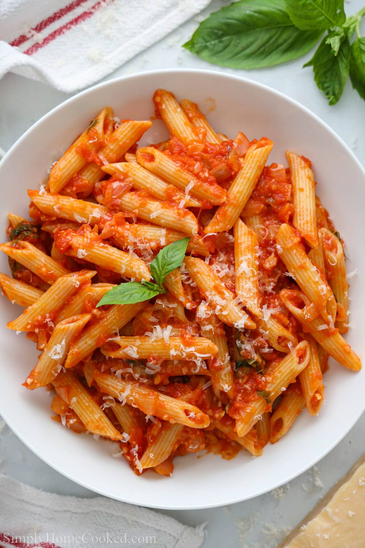 Penne Pomodoro topped with fresh basil.