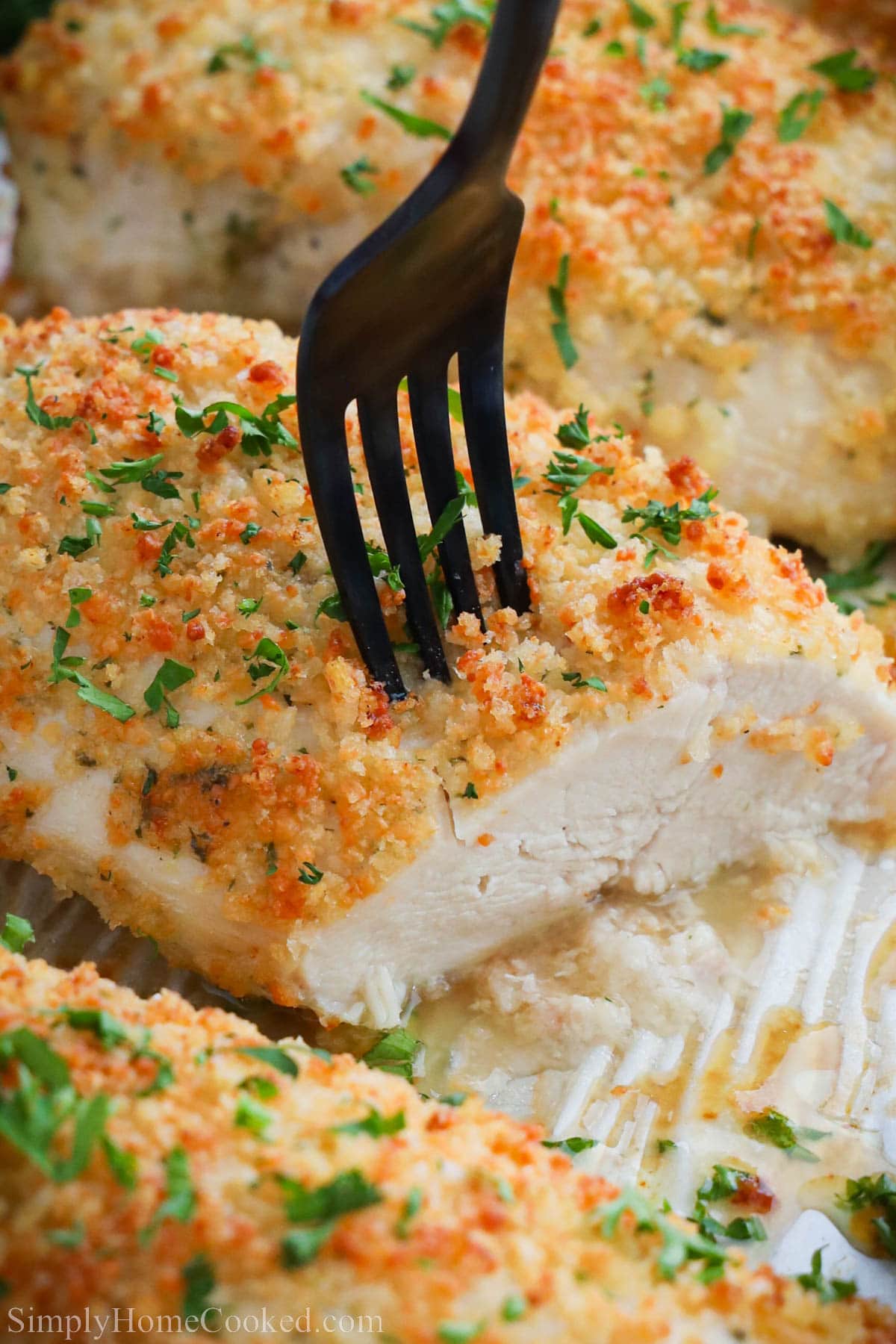 Close up of fork in Baked Ranch Chicken. 